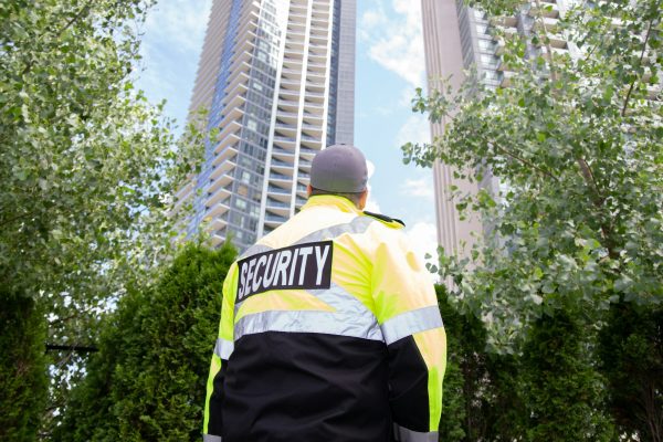 Security guard in uniform patrolling a residential area.