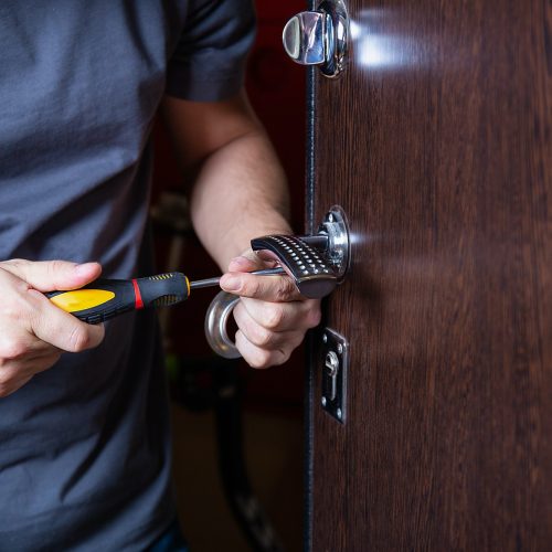 Locksmith replacing door lock to new after losing keys. Robbery protection