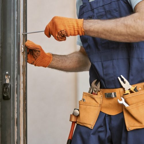 male-hands-in-gloves-repairing-door-in-house.jpg